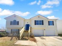 Charming two-story home with a blue front door, two-car garage and a spacious front yard at 3399 Springside Rdg, Decatur, GA 30034