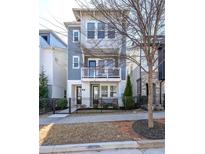 Charming three-story home featuring a balcony, white trim, and a well-maintained yard at 419 Hargrove Ln, Decatur, GA 30030