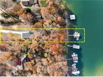 Expansive waterfront property with dock, boat slip, and surrounding trees and lake views at 6178 Lake Lanier Heights Rd, Buford, GA 30518