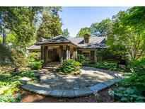 Charming home with a landscaped front yard, stone walkway, and covered entryway at 690 Old Ivy Ne Rd, Atlanta, GA 30342