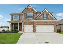Beautiful brick home featuring a manicured lawn, two-car garage, and well-maintained landscaping at 2875 Bluestone Sw Dr, Atlanta, GA 30331