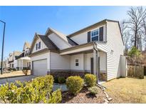 Charming home with a stone-accented facade, attached garage, manicured landscaping, and inviting covered entry at 196 Foggy Creek Lane Ln, Hiram, GA 30141