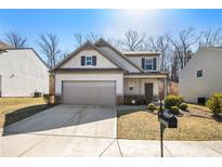 Charming home with neutral siding, stone accents, two car garage and inviting front porch, plus manicured lawn at 196 Foggy Creek Lane Ln, Hiram, GA 30141