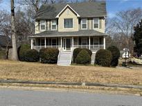 Charming two-story home featuring a welcoming front porch and well-maintained landscaping at 722 Thornapple Trl, Lawrenceville, GA 30046