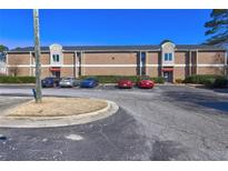 Brick condo building with well-maintained landscaping and convenient parking at 3301 Henderson Mill Rd, Atlanta, GA 30341