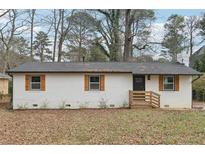 Charming renovated brick home with black trim, wooden shutters, and a new roof at 1700 Shirley Sw St, Atlanta, GA 30310