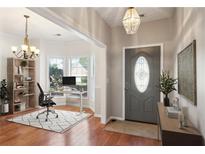 Inviting entryway features gleaming hardwood floors, stylish decor, and bright natural light from the adjacent office area at 3331 Freedom Nw Lndg, Kennesaw, GA 30144