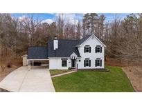 Charming two-story home with black shutters, covered parking, and a well-manicured lawn at 5130 Forest Hills Ct, Cumming, GA 30041