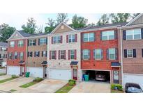 Charming multi-level townhomes showcasing diverse brick and siding exteriors with private garages at 2137 Post Grove Rd, Snellville, GA 30078
