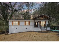 Single-story home featuring mature landscaping with a modern porch, and an inviting exterior design at 2166 Ohara Se Pl, Atlanta, GA 30315