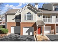 Charming townhouse with brick facade, attached garage and bright red front door at 704 Spring Heights Se Ln # 7, Smyrna, GA 30080