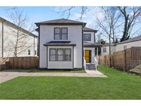 Charming two-story home boasts fresh green lawn and a cheerful yellow front door at 1088 Hubbard Sw St, Atlanta, GA 30310