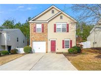 Charming two-story home with a brick accent, attached garage, red door and shutters, and a well-manicured lawn at 118 Silver Fox Trl, Dallas, GA 30157