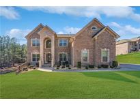 Beautiful two-story brick home with well-manicured lawn and mature trees at 6117 Summerstone Ln, Douglasville, GA 30135