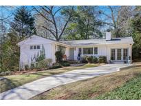 Charming brick home with a well-manicured lawn and inviting driveway at 2530 Parkdale Ne Pl, Atlanta, GA 30305