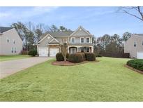 Charming two-story home featuring a well-manicured lawn and a classic brick and siding facade at 2441 Greenside Ct, Austell, GA 30106