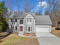Charming two-story home featuring a gray exterior, well-manicured front yard, and attached two-car garage at 12270 Leeward Walk Cir, Alpharetta, GA 30005