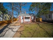 Charming brick home with a well-maintained front yard and classic architectural details at 1475 Elizabeth Ln, Atlanta, GA 30344