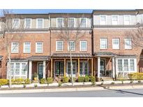 Beautiful brick townhome with a welcoming porch and well-maintained landscaping at 225 Waterman Se St, Marietta, GA 30060