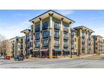 Modern apartment building featuring stylish architecture, multiple balconies, and street-level commercial spaces at 5300 Peachtree Rd # 1311, Atlanta, GA 30341