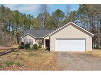 Charming single-story home with a two-car garage and well-maintained front lawn at 403 Keys Ferry Rd, Mcdonough, GA 30252