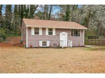 Charming single-Gathering home with a well-maintained front yard and light-colored shutters at 4042 Sweetbriar Ln, Forest Park, GA 30297