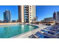 Beautiful rooftop pool with lounge chairs and city views at 860 Peachtree Ne St # 917, Atlanta, GA 30308