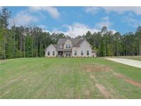 Stunning two-story home with a manicured lawn and lush surrounding greenery, radiating curb appeal at 31 Homesite Cooper E Cv, Fayetteville, GA 30214