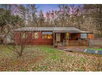 Charming single-story home with a sloped yard and a metal roof at 4166 Hall Se St, Acworth, GA 30102