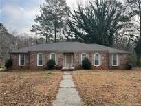 Charming brick home with a well-manicured front yard and a classic, inviting entrance at 676 Bralorne Dr, Stone Mountain, GA 30087