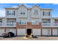 A well-maintained townhouse with brick accents, individual garages, and private balcony spaces at 107 Vinings Forest Se Cir, Smyrna, GA 30080