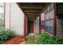 Inviting entryway of home with wood siding and well-maintained landscaping at 711 Cypress Pointe St, Johns Creek, GA 30022