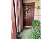 Cozy front door with a wreath, a fern and the unit number of this lovely home at 711 Cypress Pointe St, Johns Creek, GA 30022