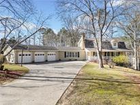 Sprawling ranch style home with a three car garage and circular drive on a large lot at 444 Pineview Dr, Canton, GA 30114