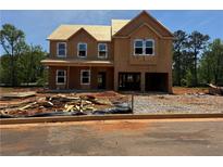 Exterior view of a two-story home under construction featuring a covered porch and an attached two-car garage at 1587 Sungrown Way, Mcdonough, GA 30253