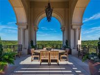 Picturesque outdoor patio with a wooden dining set surrounded by an arched colonnade and beautiful views at 3286 Northside Nw Pkwy # 304, Atlanta, GA 30327
