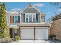 Charming two-story home with brick and gray siding and a two-car garage in a well-maintained community at 3600 Elkhorn Nw Ct, Duluth, GA 30096