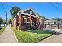 Charming brick home featuring a cozy front porch with classic architectural details and manicured landscaping at 50 Ormond Sw St, Atlanta, GA 30315