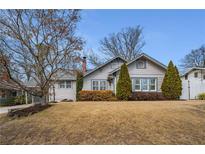 Quaint single-Gathering home with a well-manicured front yard and a charming front porch at 1923 Rugby Ave, Atlanta, GA 30337