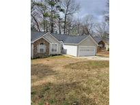 Charming single-story home with stone accents, vinyl siding and a two-car garage at 2071 Boone Pl, Snellville, GA 30078