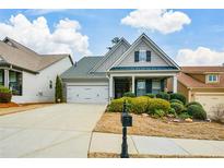 Charming single-story home with a manicured lawn and inviting front porch at 505 Appalachian Woods Dr, Canton, GA 30114