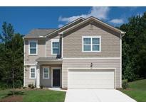Charming two-story home with manicured lawn and attached two-car garage, perfect for suburban living at 7728 Sudbury Cir, Covington, GA 30014