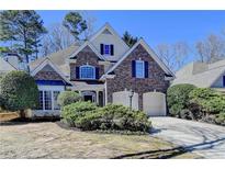 Charming two-story brick home with a well-manicured front yard and attached two-car garage at 1217 Indian Hills Pkwy, Marietta, GA 30062