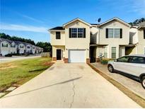 Traditional two-story home with a one car garage, black shutters, and a long driveway at 2399 Coach Way, Jonesboro, GA 30236