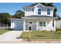 Charming two-story home with a front porch, attached garage, and newly installed driveway in a quiet neighborhood at 2414 Rose Palm Pl, Atlanta, GA 30315