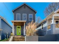 Charming two-story home with a bright green door and well-maintained landscaping at 480 Rockwell Sw St, Atlanta, GA 30310