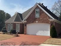 Charming brick home with a brick driveway and manicured landscaping at 2392 Ivy Mountain Dr, Snellville, GA 30078