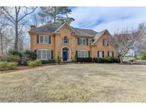 Traditional brick home with well-manicured lawn and mature landscaping, boasting curb appeal at 93 Ridgetree Ln, Marietta, GA 30068