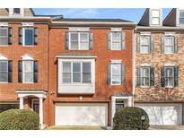 Charming brick townhouse with well-maintained landscaping and attached two-car garage at 612 Vinings Estates Se Dr # B12, Smyrna, GA 30126