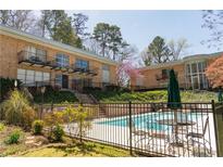 Exterior view featuring a pool, outdoor seating, and well-maintained landscaping at 1235 Woodland Ne Ave # 1, Atlanta, GA 30324